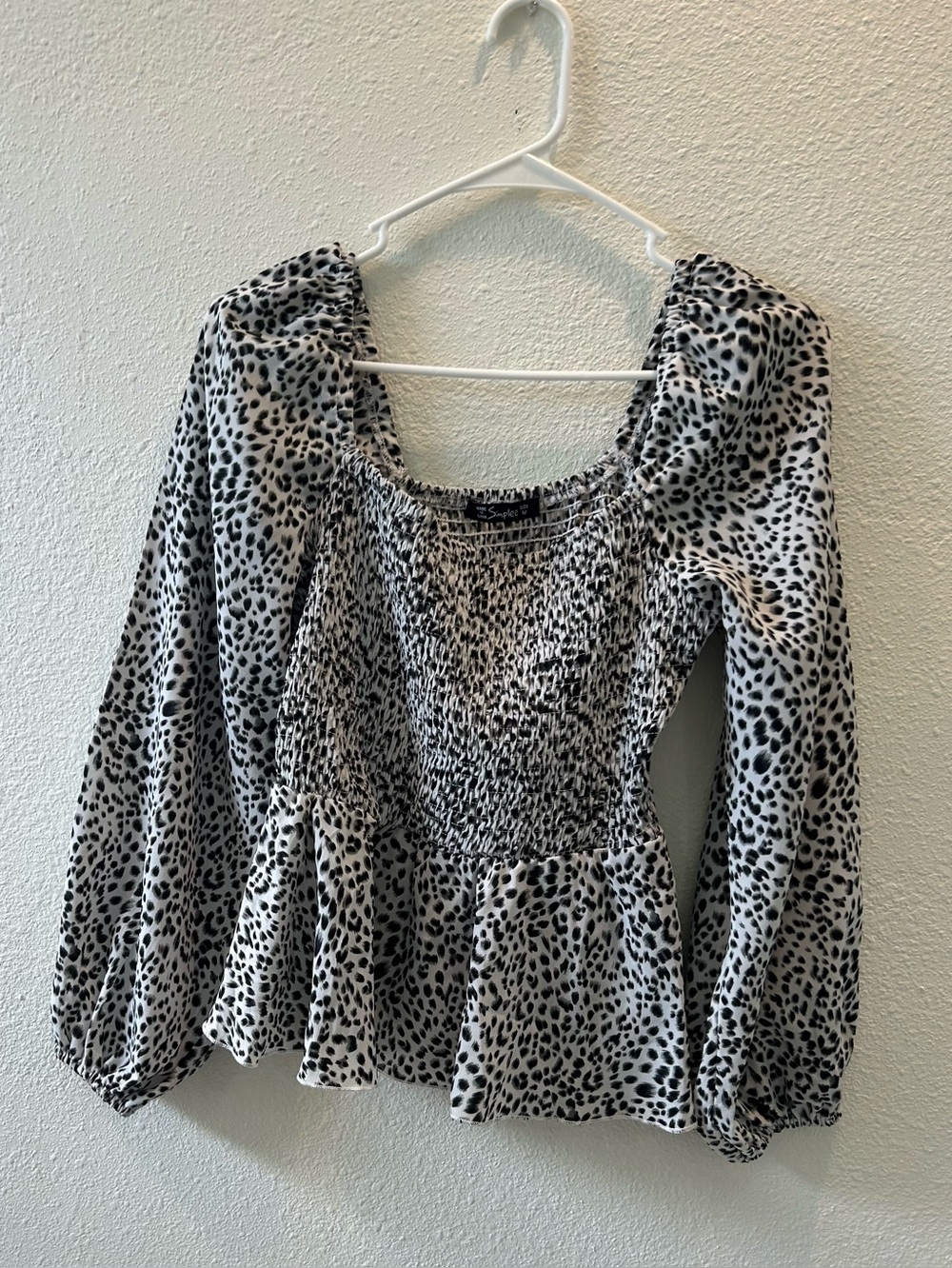 Simplee Apparel Black & White Leopard Smocked Peplum Blouse